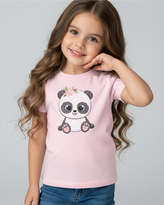 Girl wearing light pink kids t-shirt with cute floral panda graphic, studio background