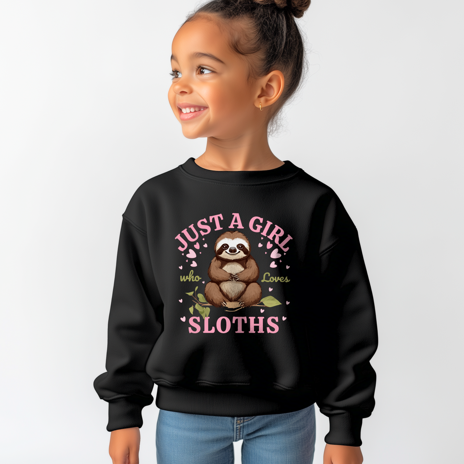 Young girl smiling and wearing a black “Just a Girl Who Loves Sloths” sweatshirt with a cute sloth and pink hearts on the front.