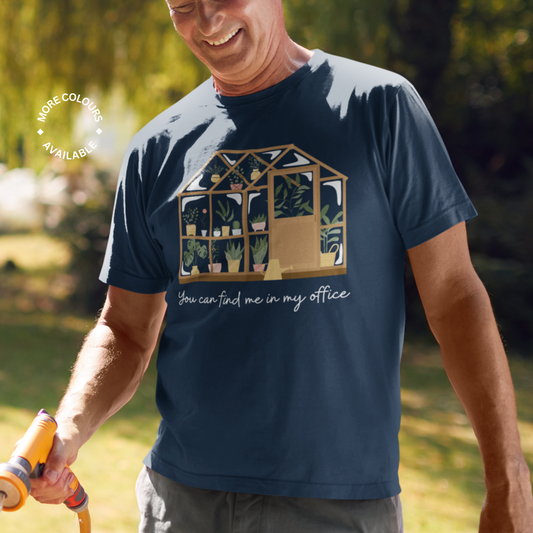 Smiling man holds hose in a navy "You can find me in my office" greenhouse t-shirt