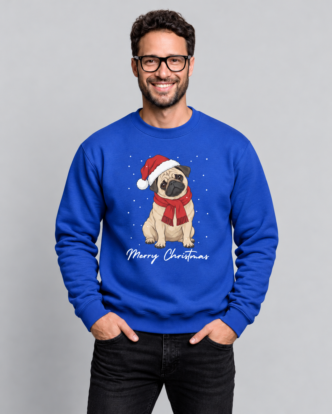 A man wearing a royal blue crewneck sweatshirt with a graphic of a pug wearing a Santa hat and scarf, with 'Merry Christmas' written below, against a solid gray background.