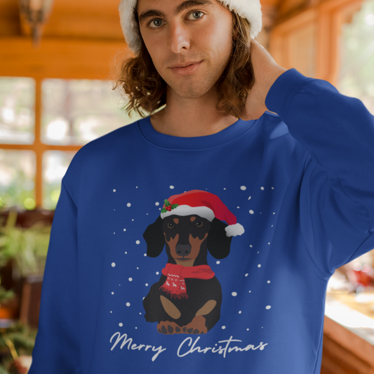 A man wearing a blue Christmas-themed sweatshirt with a dachshund and 'Merry Christmas' text.