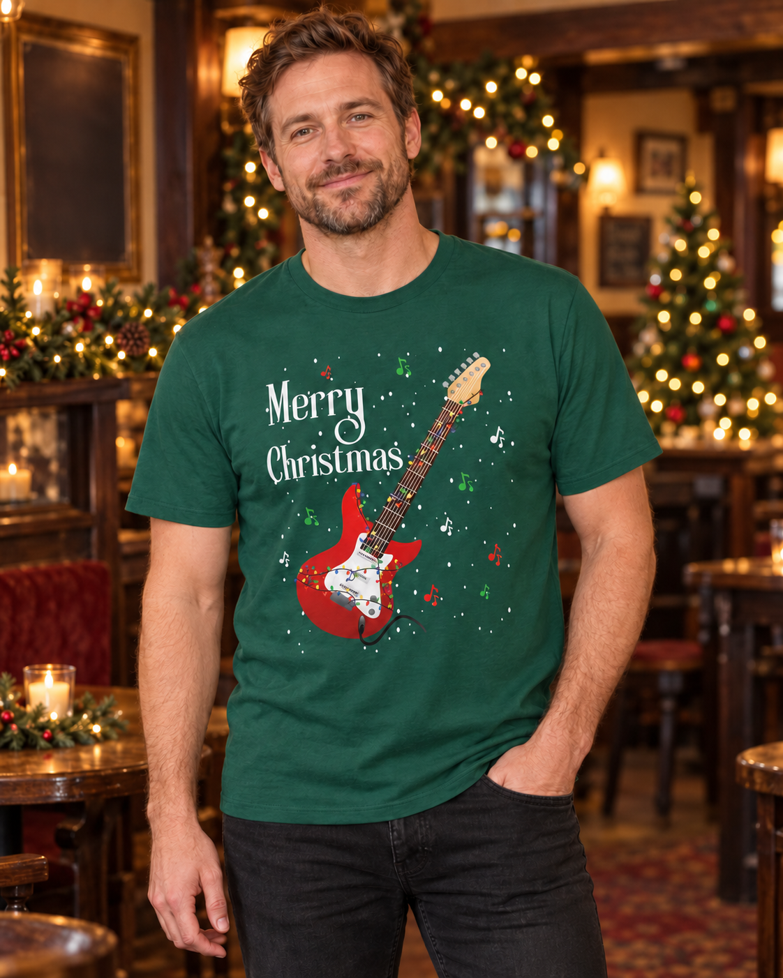 Man wearing a dark-green electric guitar Christmas T-shirt with black jeans in a warmly decorated festive pub.