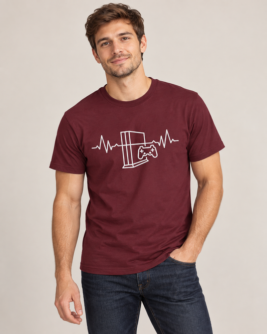 Man wearing a maroon gaming T-shirt with a white console, controller and heartbeat graphic