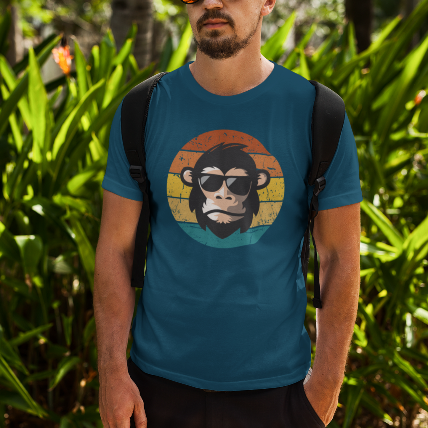 Man wearing a deep teal retro chimp graphic t-shirt.