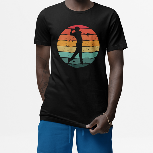 Man wearing a black t-shirt with a colourful graphic of a silhouette golfer on a vintage sunset background