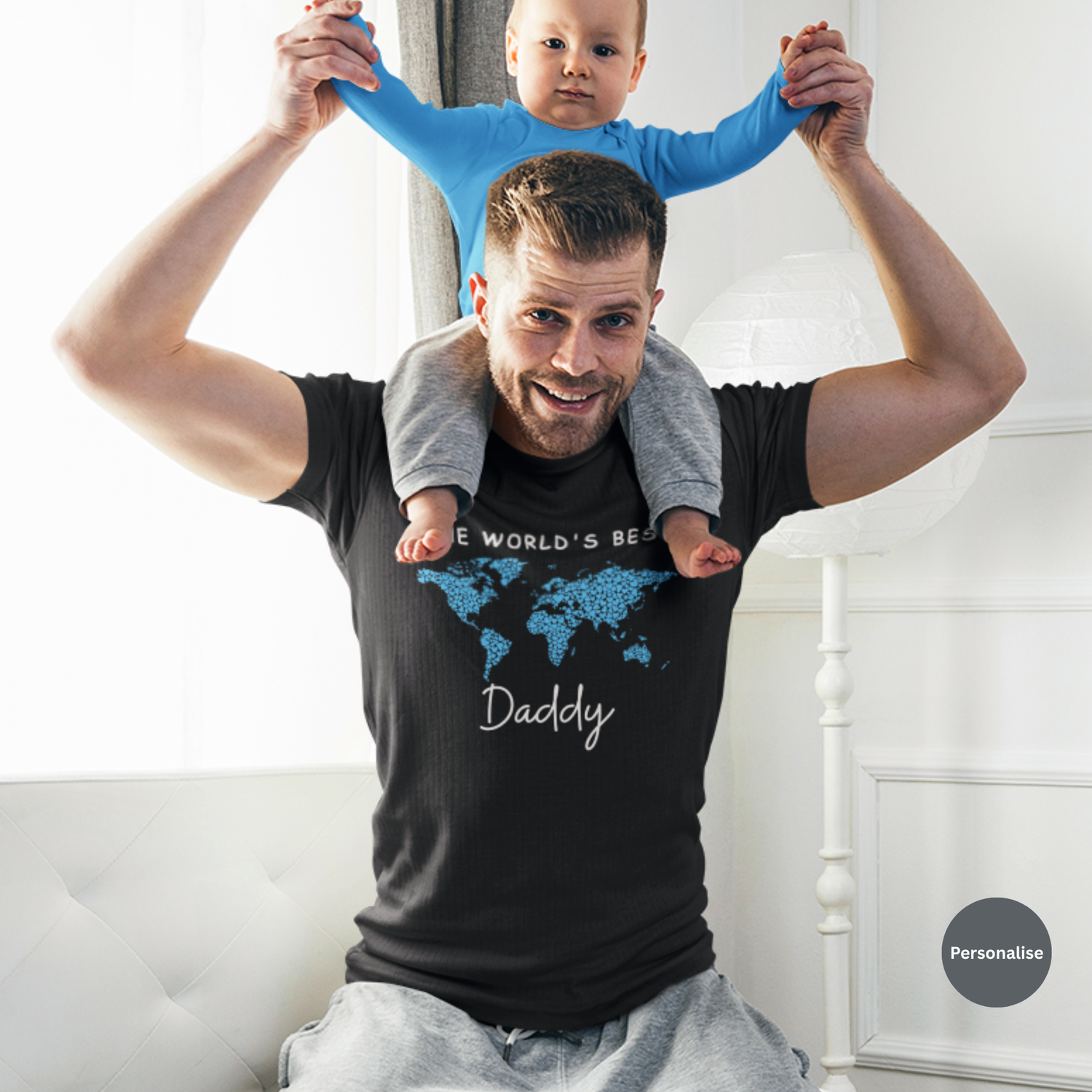 New dad wearing black “World’s Best Daddy” personalised t-shirt holding baby on shoulders