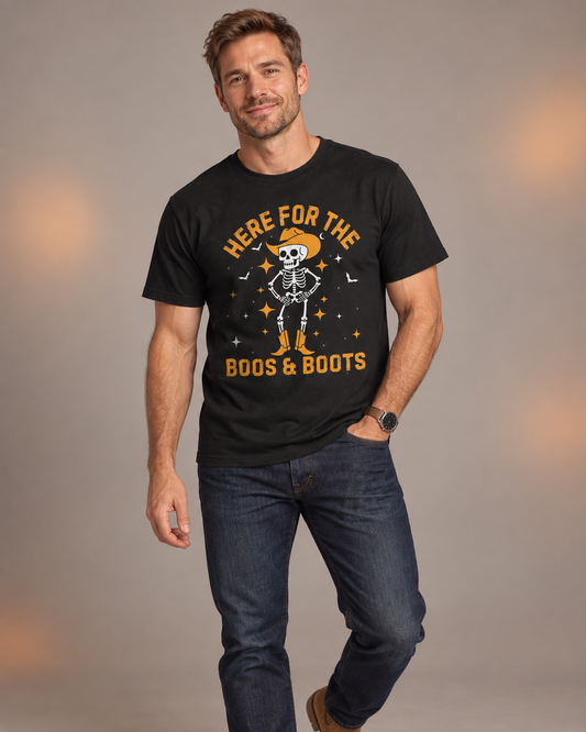 Man wearing a black “Here for the Boos & Boots” Halloween T-shirt featuring a cowboy skeleton, styled with dark jeans.