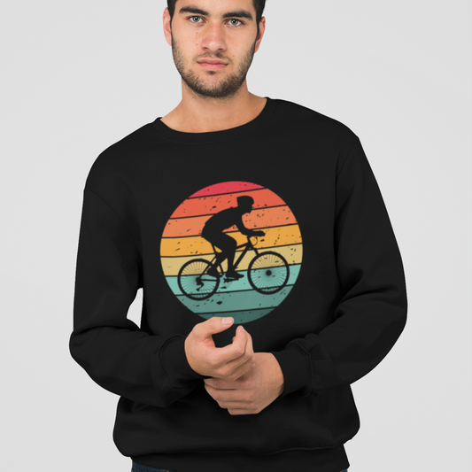 Man wearing a black sweatshirt with a retro sunset graphic and cyclist silhouette printed on the front