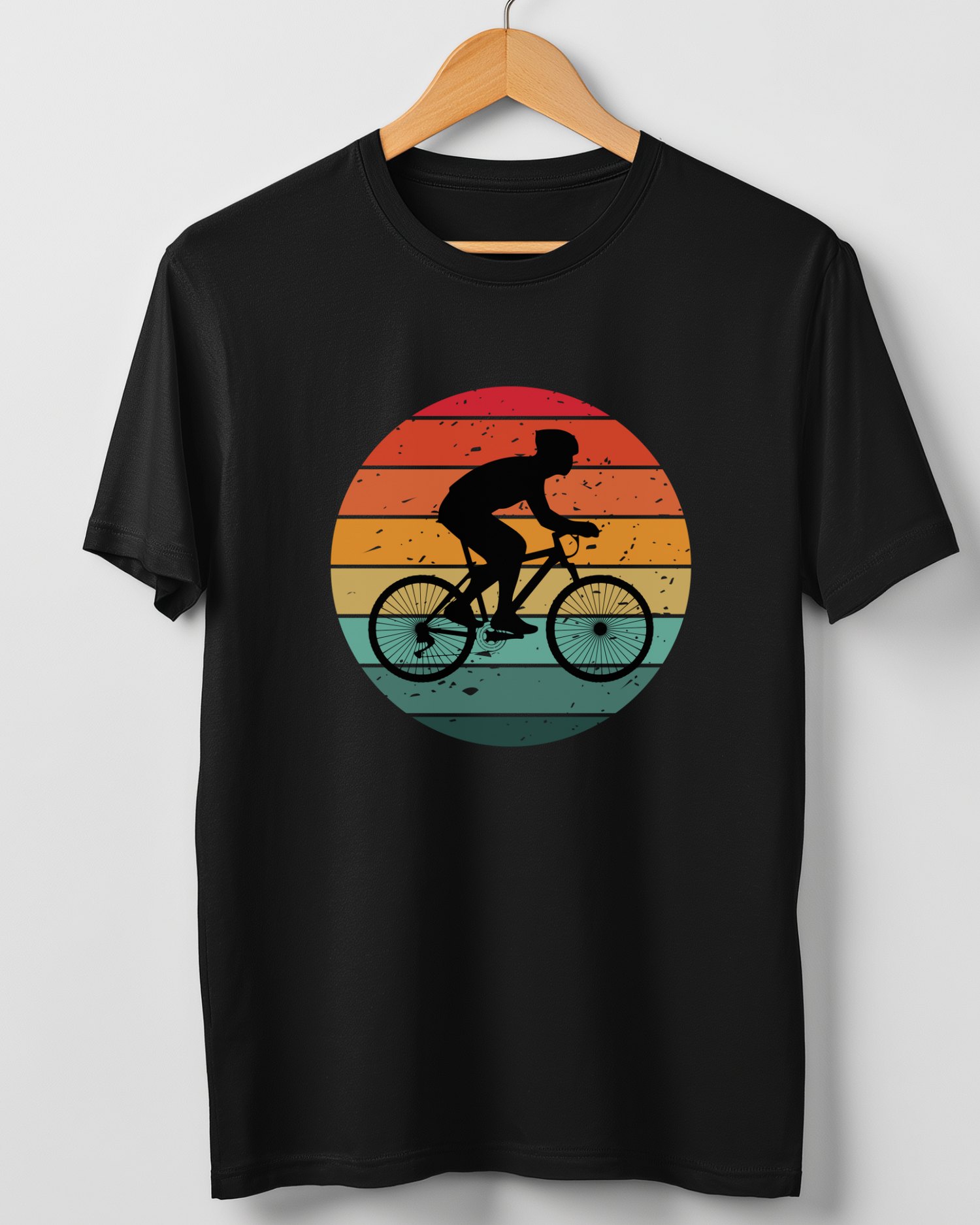 Black men’s T-shirt on a wooden hanger featuring a retro sunset cyclist design.