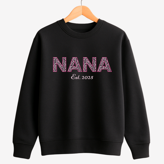 Black personalised “NANA Est. 2025” leopard print sweatshirt on wooden hanger