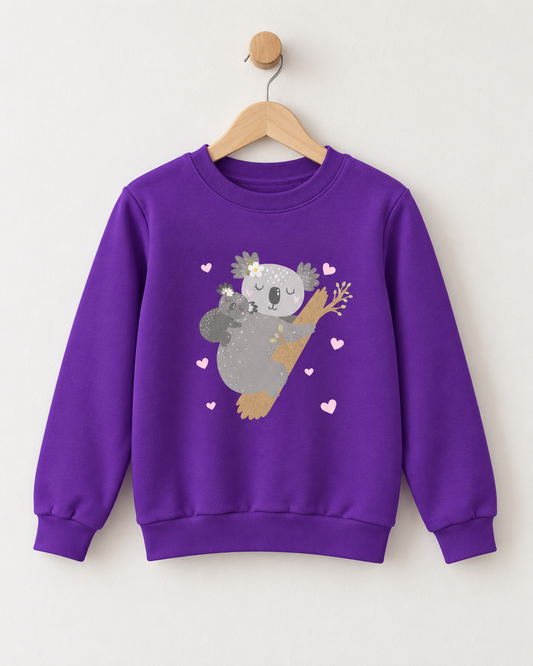 Purple kids crewneck sweatshirt on a wooden hanger, featuring an illustration of a mother and baby koala cuddling on a tree branch surrounded by small pink hearts.