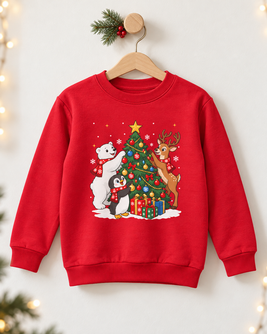 A kids-red crewneck sweatshirt hanging on a wooden hanger against a white wall, decorated with a festive Christmas graphic featuring a polar bear, penguin, reindeer, and a decorated tree.