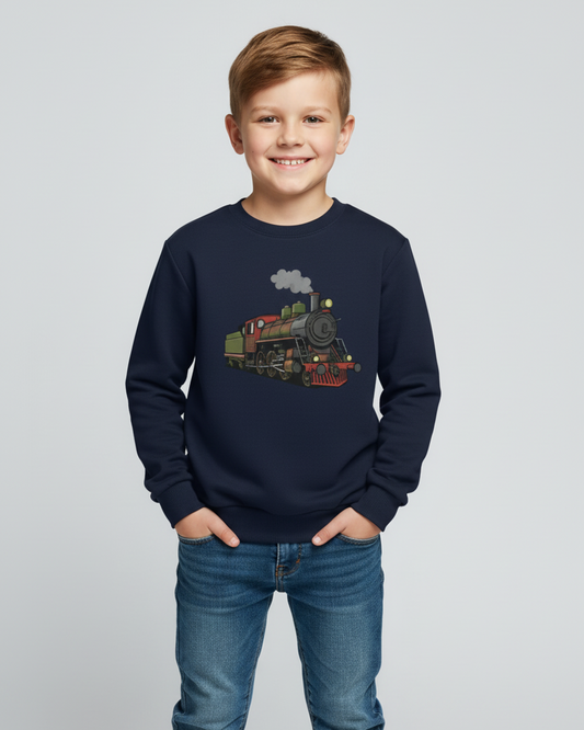 Smiling boy wearing a navy children’s sweatshirt featuring a vintage steam train design, styled with blue jeans in a bright studio setting.