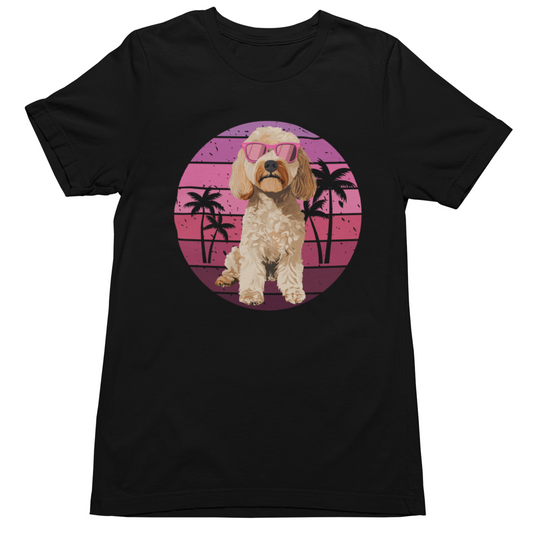 Black t-shirt featuring a retro summer sunset circle with palm trees and a cockapoo wearing pink sunglasses graphic