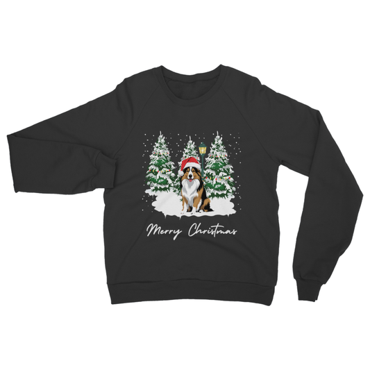 Black Christmas sweatshirt with rough collie dog in a Santa hat sitting between snowy Christmas trees and “Merry Christmas” text.