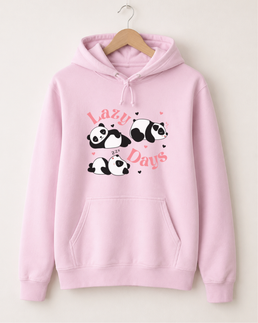 Women's light pink pullover hoodie hanging on a wooden hanger against a plain off-white wall. The hoodie features a front graphic with four cartoon pandas and the words 'Lazy Days' in pink script.