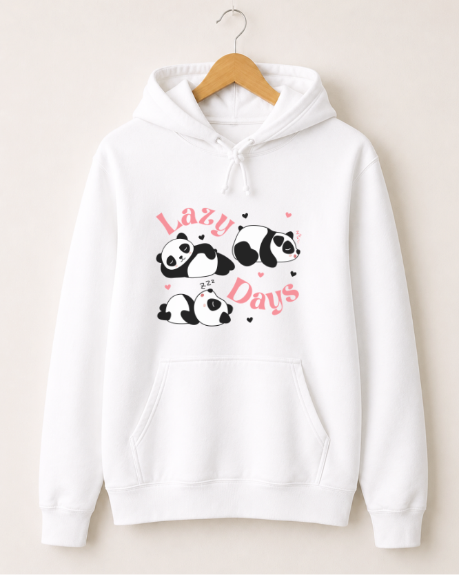 Adults white pullover hoodie hanging on a wooden hanger against a light beige wall. The hoodie features a graphic print of four cartoon pandas with pink text reading 'Lazy Days' and small pink hearts.