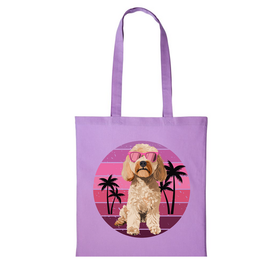 Lavender cotton tote bag with a retro-themed design featuring a cockapoo wearing pink sunglasses, surrounded by a pink sunset and palm trees.