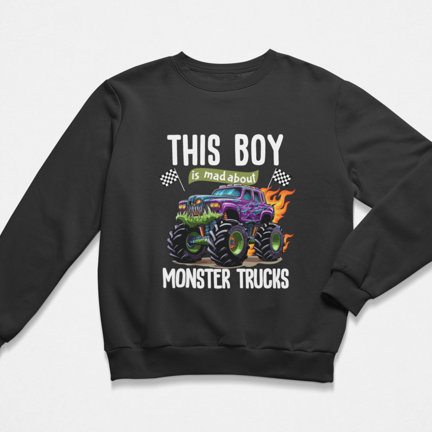 Kids black crewneck sweatshirt featuring a colourful graphic of a purple and green monster truck with flames, accompanied by the text 'THIS BOY is mad about MONSTER TRUCKS' in white and green.