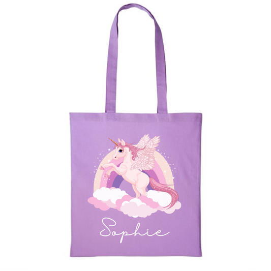 Girls lilac cotton tote bag featuring a pastel coloured rainbow and unicorn print with the custom name in white script