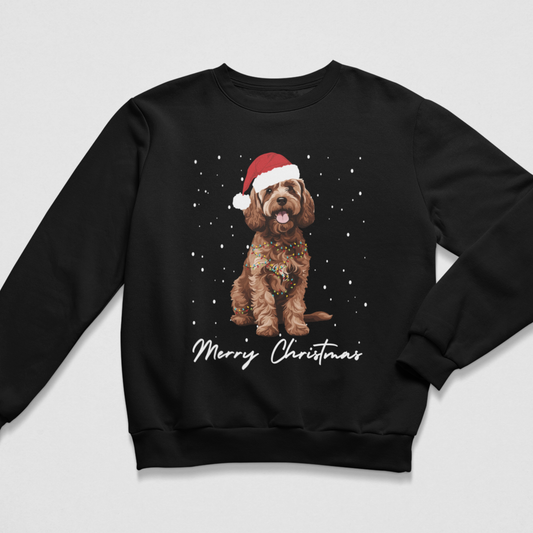 Black unisex adults Christmas jumper with brown Cockapoo wearing a Santa hat, festive lights and falling snow.