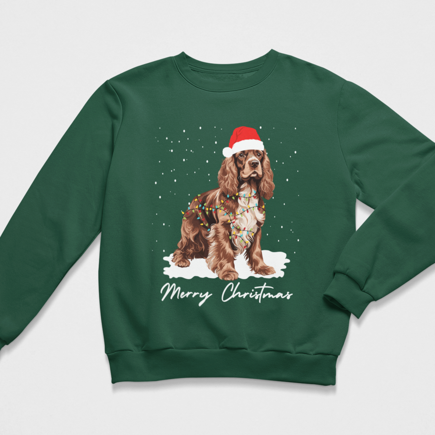 Adults dark green crewneck sweatshirt featuring a graphic of a brown and white Cocker Spaniel wearing a Santa hat and Christmas lights, sitting in the snow with 'Merry Christmas' written below.