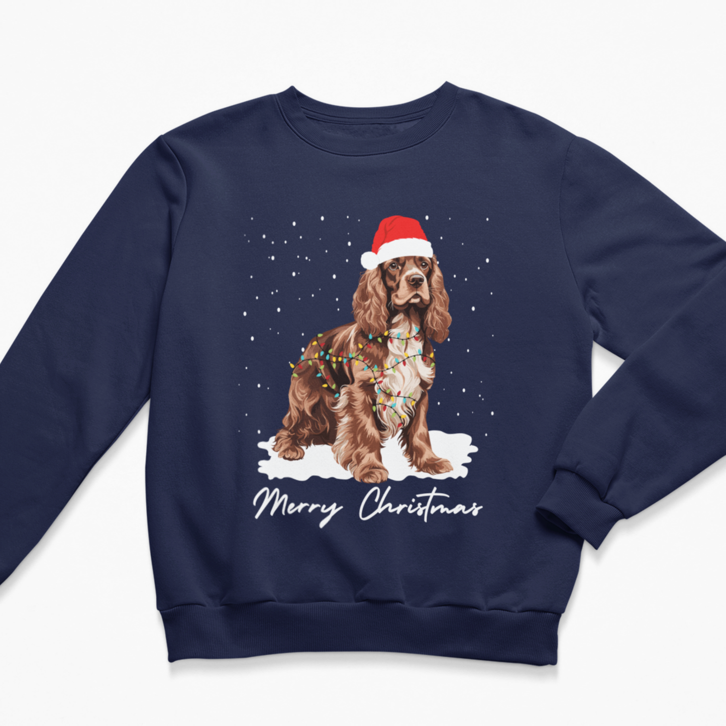 Adults navy blue crewneck sweatshirt featuring a graphic of a brown Cocker Spaniel dog wearing a red Santa hat and colourful Christmas lights, standing in the snow with 'Merry Christmas' written below.