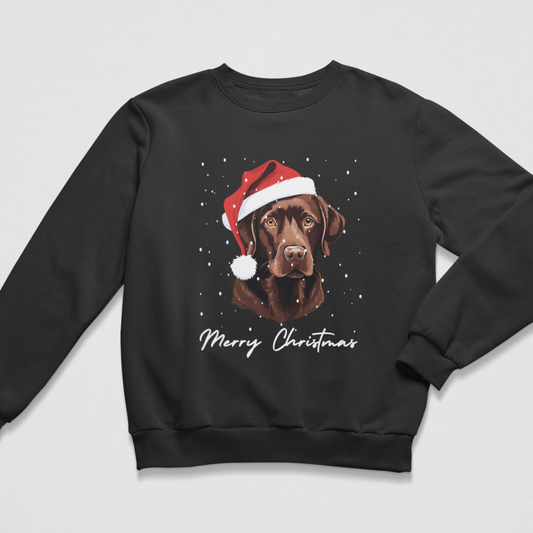 A black crewneck sweatshirt featuring a graphic of a chocolate Labrador wearing a red Santa hat, surrounded by white snowflakes, with 'Merry Christmas' written below in white script.
