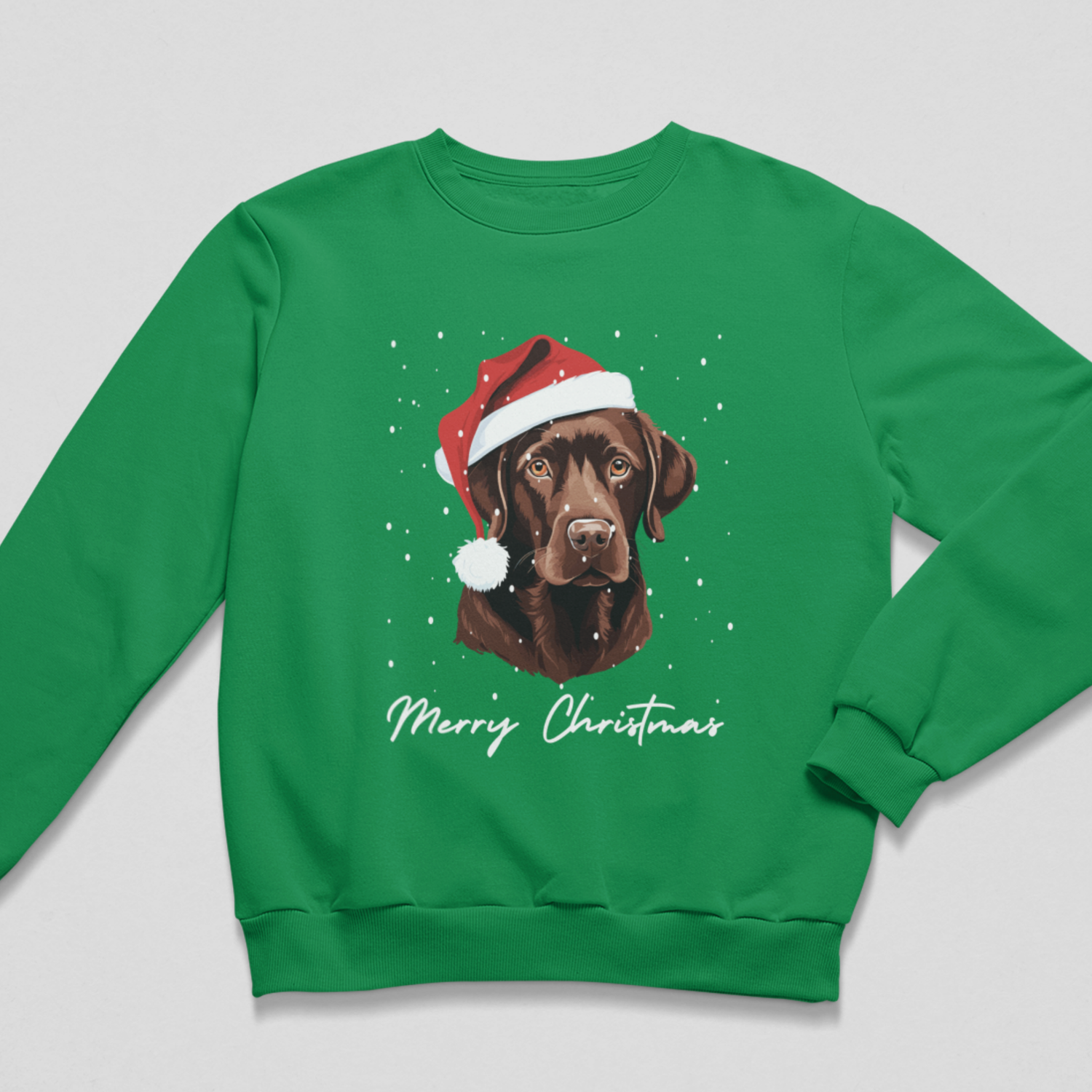 A green crewneck sweatshirt featuring a graphic of a chocolate Labrador  wearing a red Santa hat, with 'Merry Christmas' written in white script below, displayed on a light gray background.