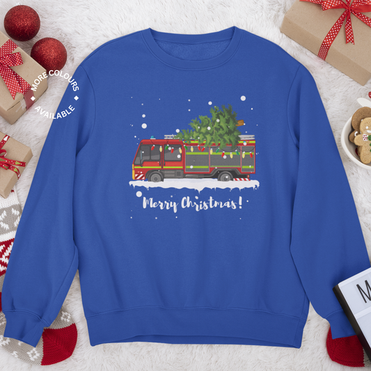 A royal blue unisex adults festive fire engine Christmas sweatshirt with a print of a fire engine carrying a Christmas tree on the roof, along with 'Merry Christmas!' text and snowflakes design.