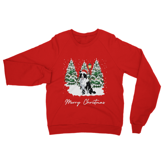 Red Christmas jumper featuring a black and white Border Collie in a snowy winter scene with Christmas trees, snow, and a festive Santa hat. Text reads “Merry Christmas.”