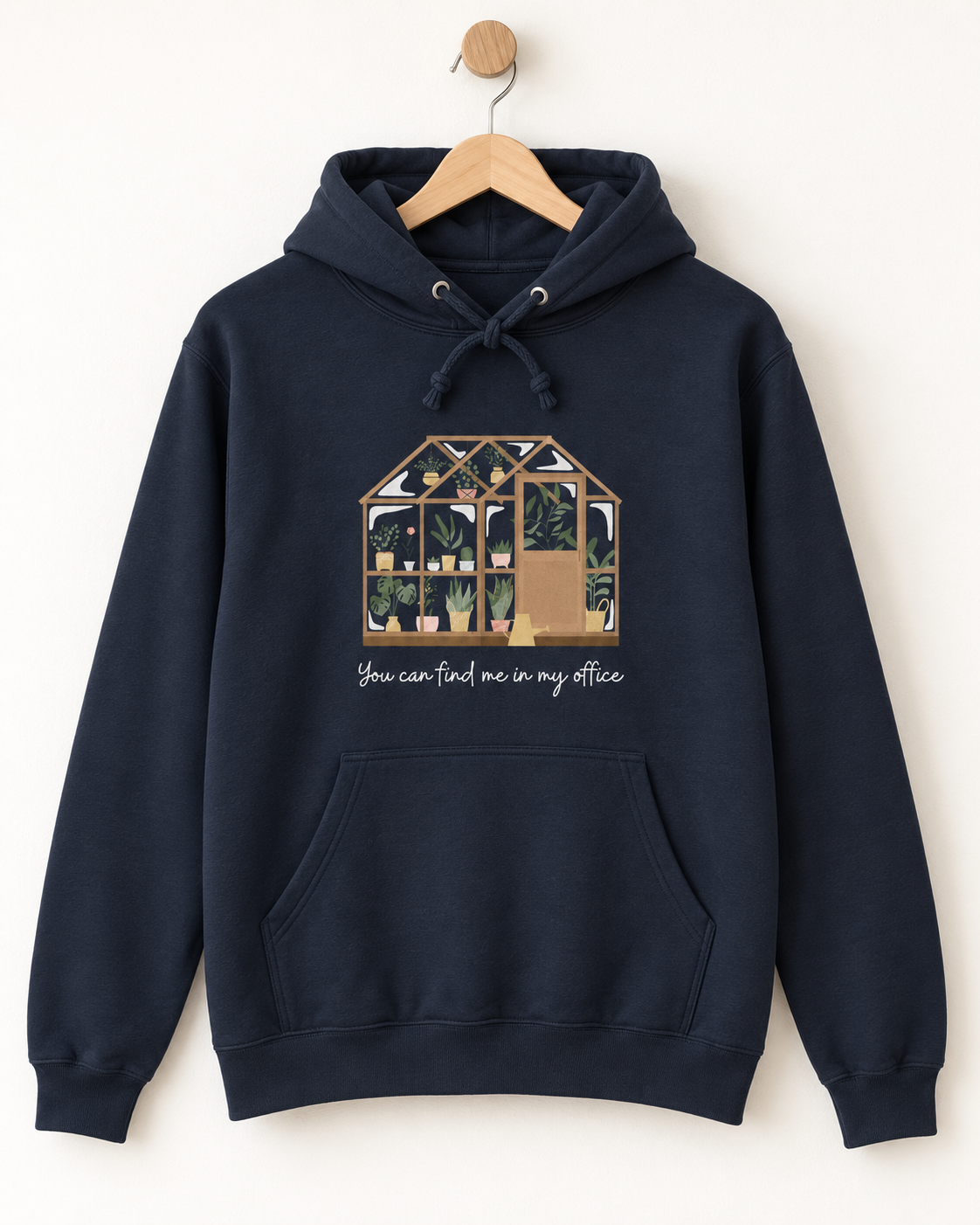 Navy greenhouse hoodie with “You can find me in my office” print displayed on a wooden hanger.