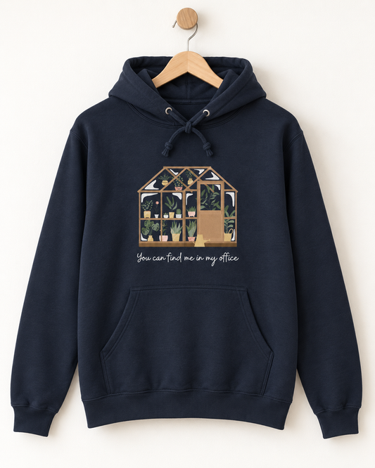 Navy greenhouse hoodie with “You can find me in my office” print displayed on a wooden hanger.