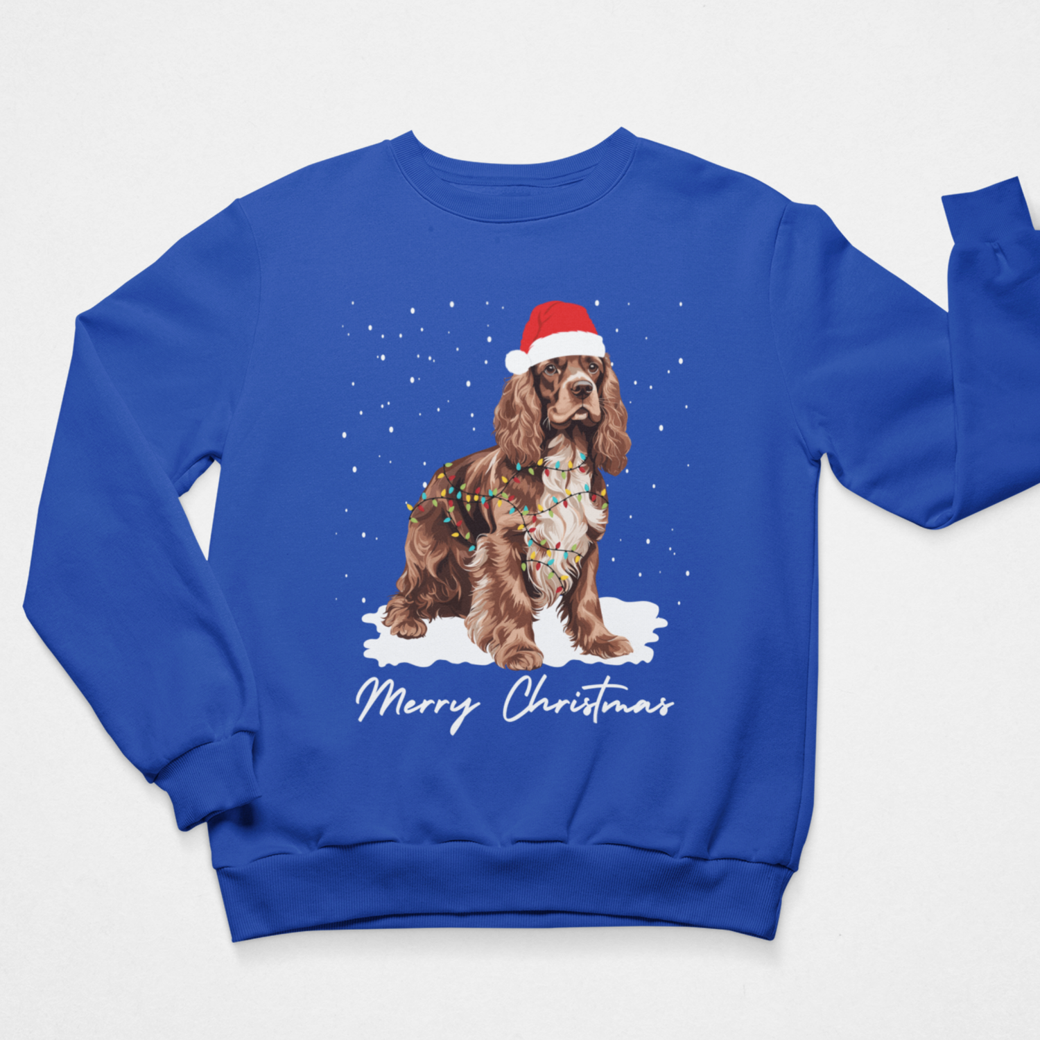 Royal blue children’s Christmas jumper showing a Cocker Spaniel tangled in colourful lights with snowy Merry Christmas print.