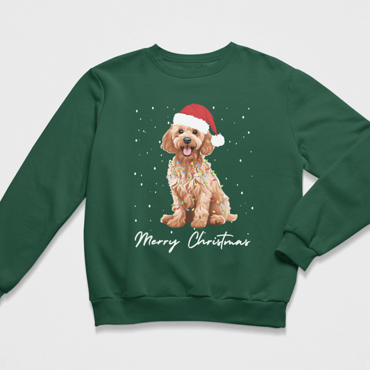 A kids dark green crewneck sweatshirt featuring a graphic of a golden cockapoo wearing a red Santa hat and holiday lights, with 'Merry Christmas' written in white script below, shown on a light grey background.