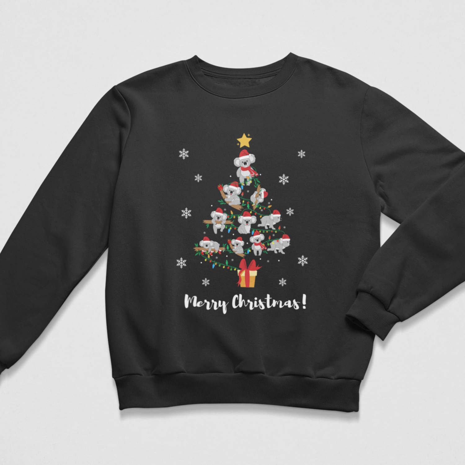 A kids black crewneck sweatshirt featuring a festive Christmas tree graphic made of cartoon koalas wearing Santa hats, surrounded by white snowflakes and the text 'Merry Christmas!' printed below.