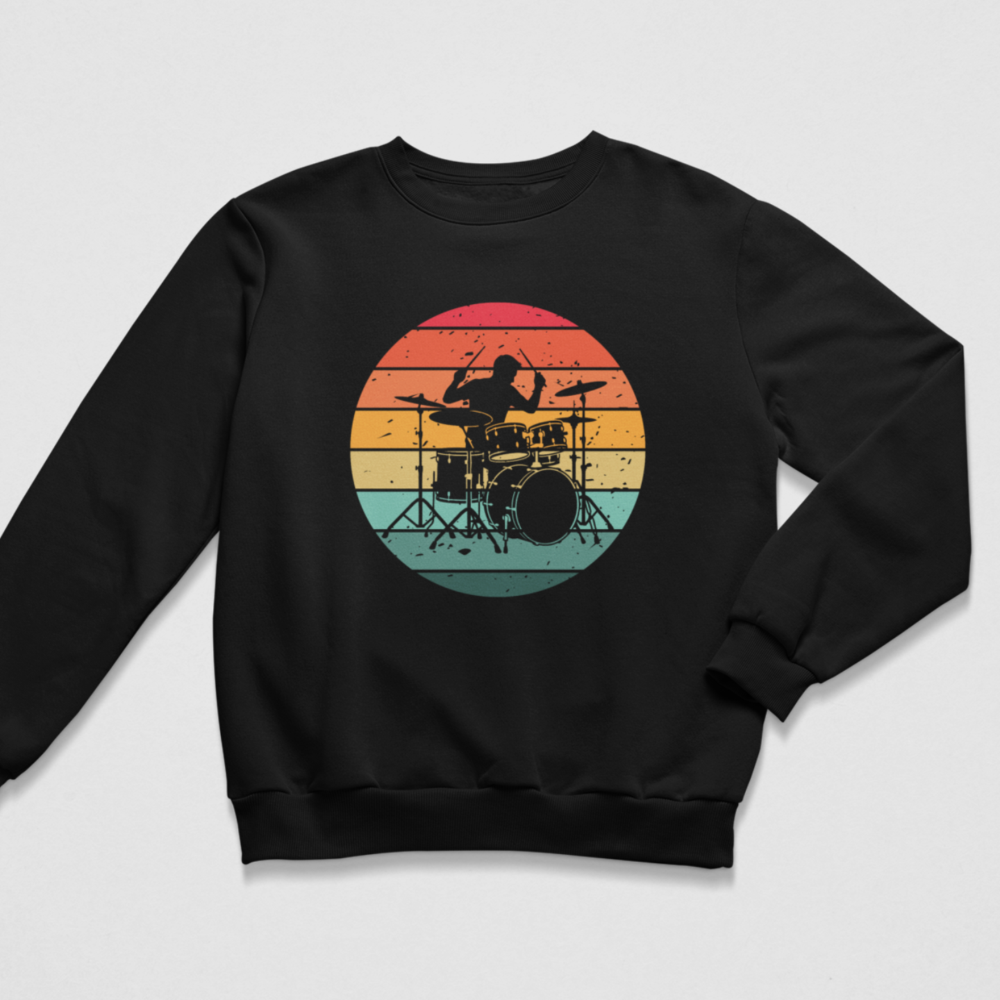 Black crew neck sweatshirt laid flat with one sleeve angled inward, displaying a circular red, orange, yellow and teal sunset drum kit design.