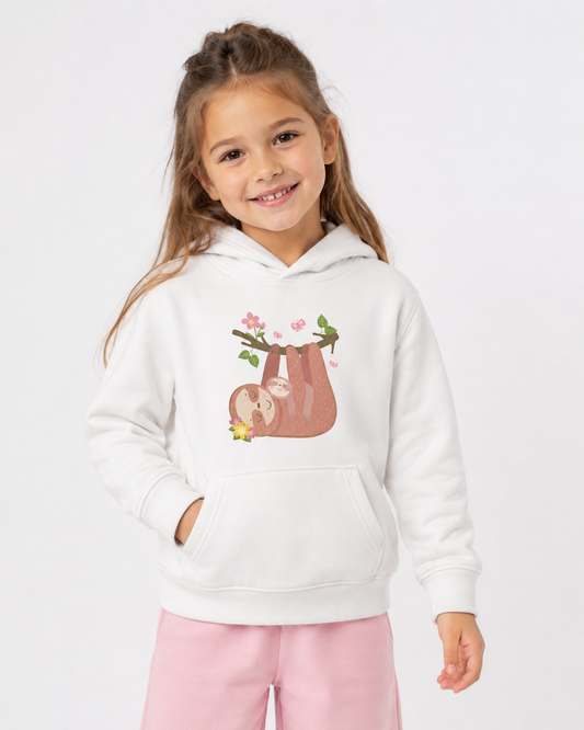 Smiling girl wearing a white kids hoodie with a mother and baby sloth hanging from a flowered branch with pink butterflies, styled with baby pink joggers.