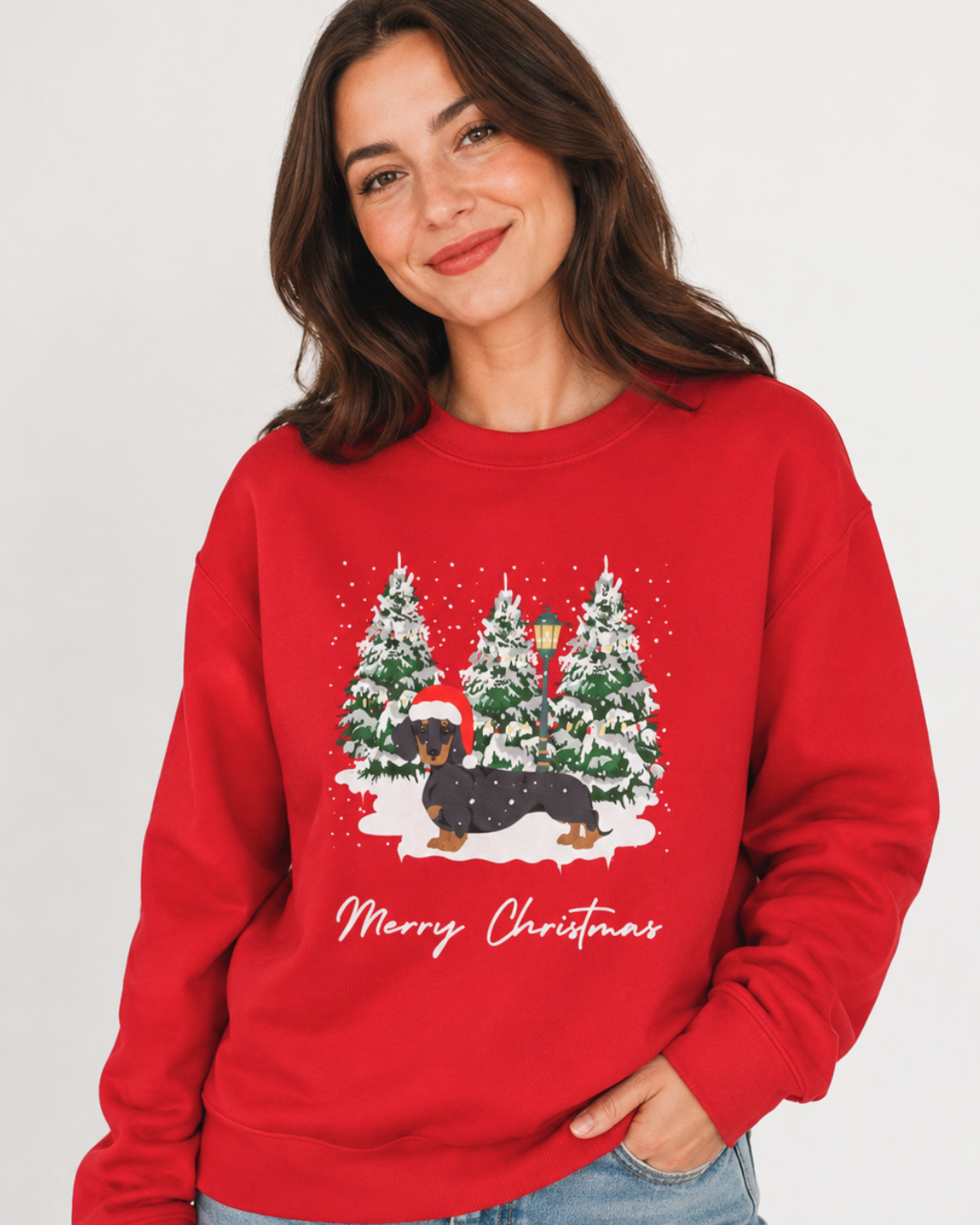 Woman wearing a red Dachshund Christmas jumper with snowy forest and Merry Christmas design