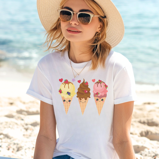 A woman relaxing on a beach wearing a white short-sleeved cotton t-shirt with printed summer kawaii-style ice cream cones small cute faces.