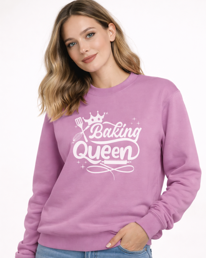Woman wearing lavender “Baking Queen” sweatshirt with crown and baking utensils graphic – women’s baking lover jumper.