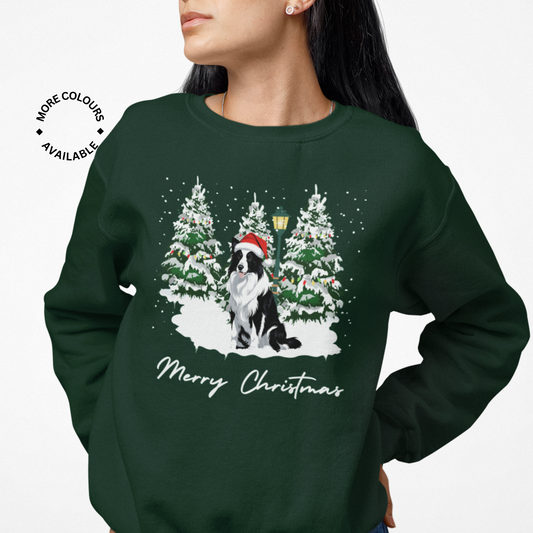 Woman wearing a dark green sweatshirt with a Christmas design of a black and white border collie dog in a Santa hat and snow-covered trees.