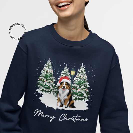 Navy blue sweatshirt with a Christmas-themed design of a rough collie dog in a Santa hat and trees, on a white background.