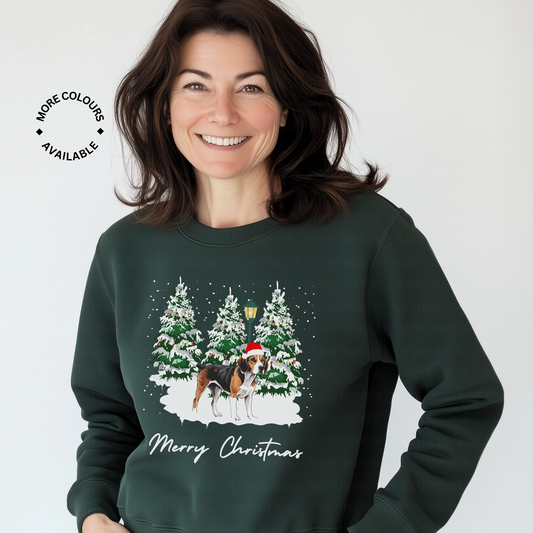 Woman wearing a green Christmas-themed sweatshirt with a beagle and snow and trees design.