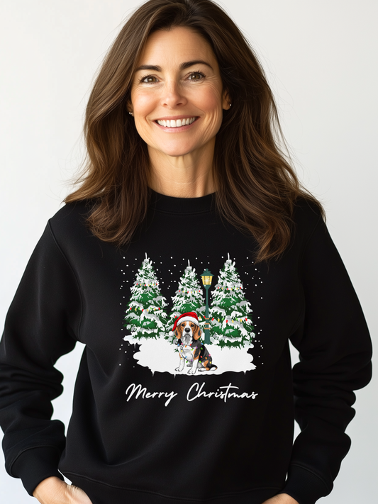 Woman wearing a black Christmas sweatshirt featuring a festive beagle in a Santa hat surrounded by snowy pine trees.