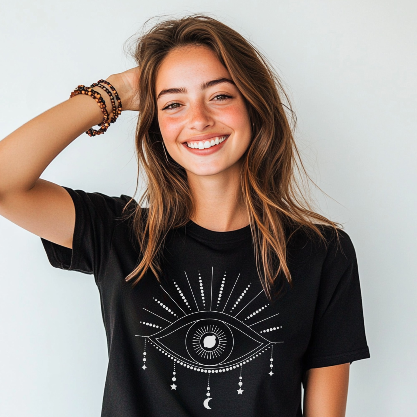 Woman wearing black Mystical Eye graphic t-shirt with white celestial eye design and radiant lines.