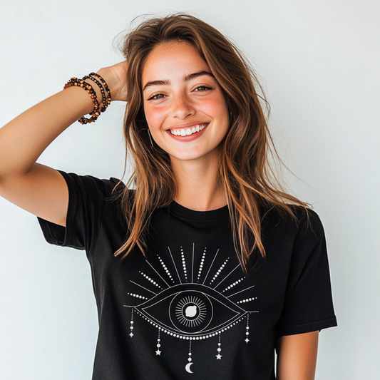 Woman wearing black Mystical Eye graphic t-shirt with white celestial eye design and radiant lines.
