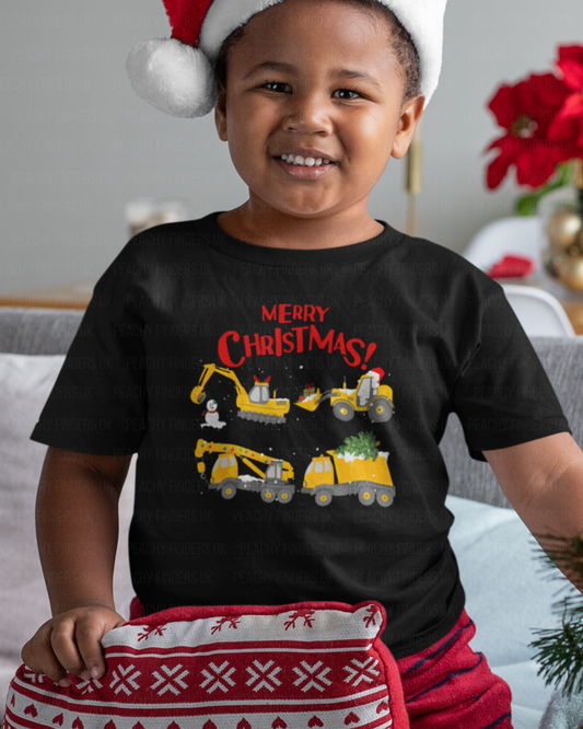 Child wearing a black kids Christmas t-shirt with “Merry Christmas” text and festive construction vehicles (digger and trucks) graphic.