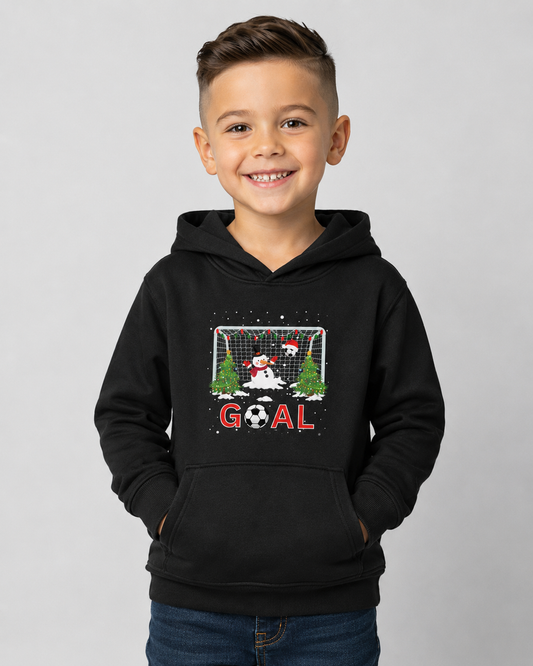 Boy wearing a black kids Christmas football hoodie with festive snowman goalkeeper, goal net, Christmas trees and bold GOAL design.