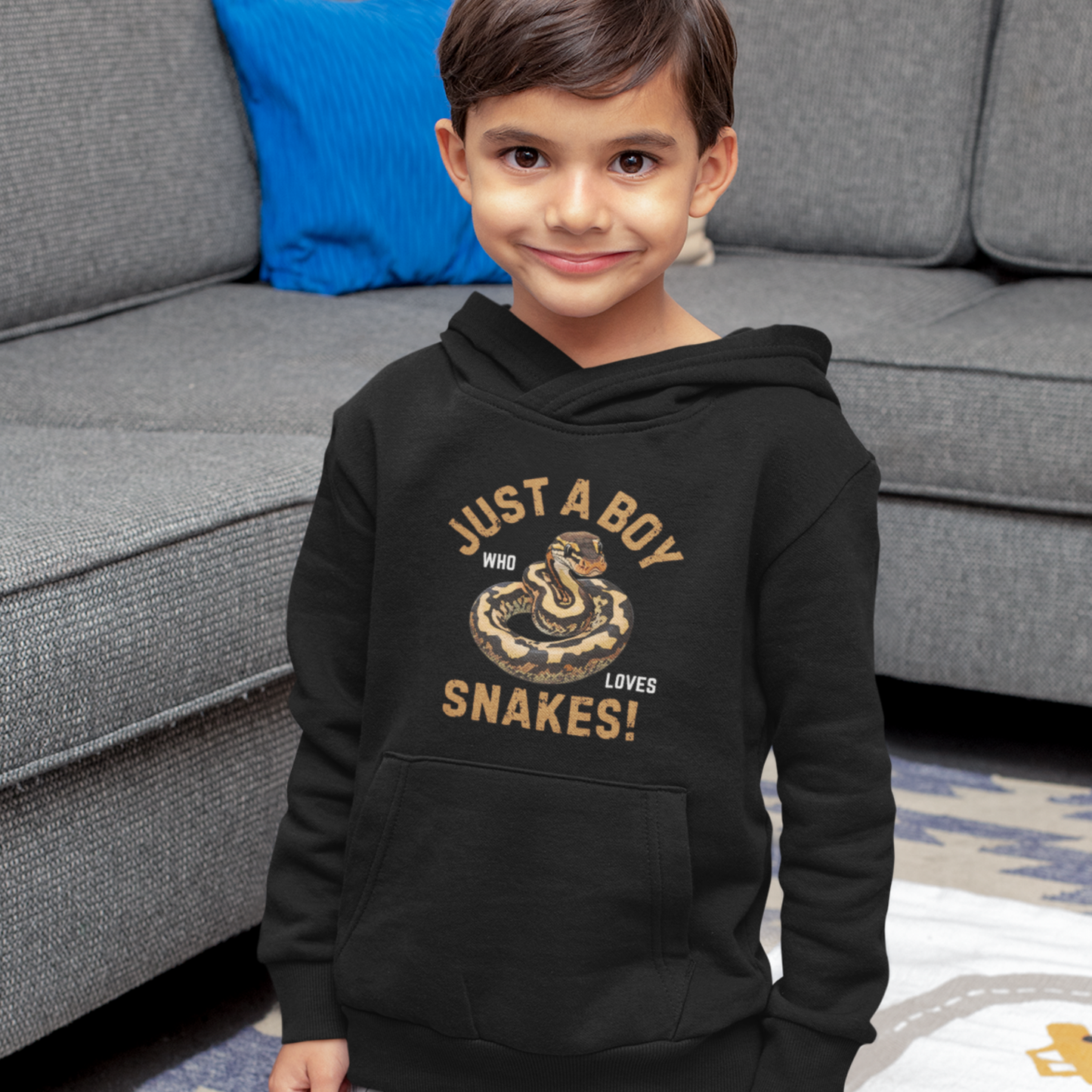 Boy wears black pullover hoodie with a ball python illustration and the text “Just a Boy Who Loves Snakes!” printed on the front. 